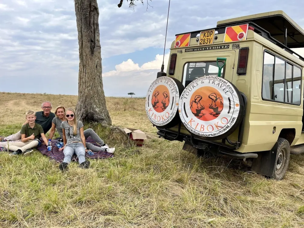 Guests beside a Kiboko safari vehicle